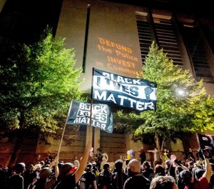 In this July 31, 2020 file photo, Black Lives Matter protesters gather at the Mark O. Hatfield United States Courthouse in Portland, Ore. (AP Photo/Noah Berger, File)
