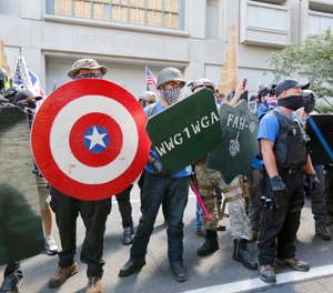 Opposing rallies battle with mace, paint balls and rocks near Justice Center in downtown Portland Saturday, August 22, 2020.