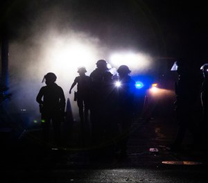 A march on the Portland police union headquarters drew a rapid police response after someone set a fire next to the building.Monday, Aug. 24, 2020.