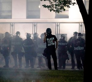 People gather Tuesday, Aug. 25, 2020 to protest in Kenosha, Wis. Anger over the Sunday shooting of Jacob Blake, a Black man, by police spilled into the streets for a third night. (AP Photo/Morry Gash)