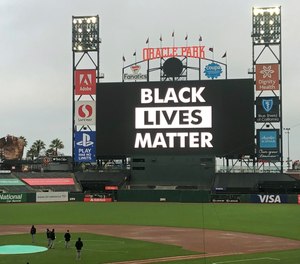 Groundskeepers work on the field at scheduled game time after a baseball game between the Los Angeles Dodgers and the San Francisco Giants was postponed on Wednesday, Aug. 26, 2020, in San Francisco.