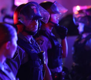 Minneapolis police secure an intersection along 7th St. during unrest near Nicollet Mall Wednesday, Aug. 26, 2020 in Minneapolis.