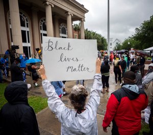 In this Thursday, June 4, 2020, file photo, a group of protesters gather outside the Glynn County Courthouse while a preliminary hearing is being held inside for Travis McMichael, Gregory McMichael and William Bryan, in Brunswick, Ga. (AP Photo/Stephen B. Morton, File)