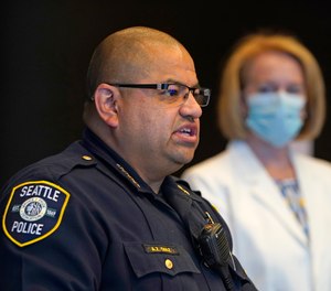 Interim Seattle Police Chief Adrian Diaz, left, addresses a news conference as Mayor Jenny Durkan looks on Wednesday, Sept. 2, 2020, in Seattle.
