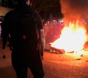 In this image taken from video a mattress burns in the street near the Portland Police Bureau's North Precinct Sunday night, Sept. 6, 2020, in Portland, Ore.