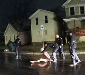 In this image taken from police body camera video, a Rochester police officer puts a spit hood over the head of Daniel Prude on March 23, 2020, in Rochester, N.Y. (Rochester Police via Roth and Roth LLP via AP)