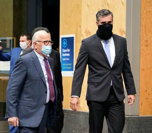 Former Minneapolis Police Officer Thomas Lane, right, walks out of a hearing with attorney Earl Gray at the Hennepin County Family Justice Center Friday, Sept. 11, 2020, in Minneapolis.