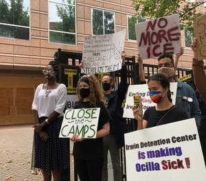 Dawn Wooten, left, a nurse at Irwin County Detention Center, speaks at a news conference protesting conditions at the immigration jail.