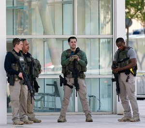 Federal law enforcement personnel stand outside the Sandra Day O'Connor Federal Courthouse Tuesday, Sept. 15, 2020, in Phoenix.