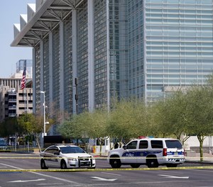 Police cars close off a street outside the Sandra Day O'Connor U.S. Courthouse in Phoenix, on Tuesday, Sept. 15, 2020.