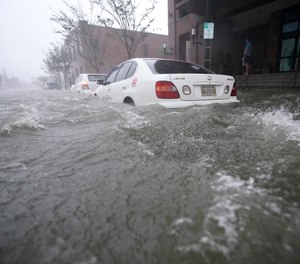 Flood waters move on the street, Wednesday, Sept. 16, 2020, in Pensacola, Fla. Hundreds of people required evacuation or rescue after the Category 2 Hurricane Sally made landfall last week.