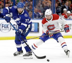 In this March 5, 2020, file photo, Tampa Bay Lightning defenseman Victor Hedman (77) breaks up a pass intended for Montreal Canadiens center Nick Suzuki (14) during the first period of an NHL hockey game in Tampa, Fla.