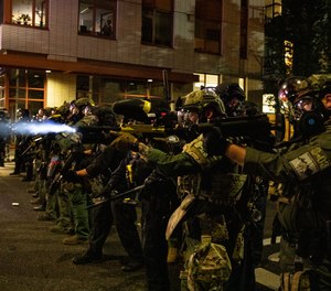 In this Friday, Sept. 18, 2020, file photo, Federal police try to take control of the streets during protests in Portland, Ore.