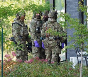 Royal Canadian Mounted Police officers prepare to enter an apartment complex in connection with the mailing of ricin to President Trump Monday, Sept. 21, 2020 in St. Hubert, Canada.