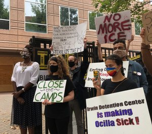 In this Tuesday, Sept. 15, 2020, file photo, Dawn Wooten, left, a nurse at Irwin County Detention Center in Ocilla, Georgia, speaks at a news conference in Atlanta protesting conditions at the immigration jail. (AP Photo/Jeff Amy, File)