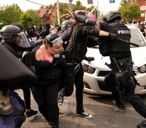 Police and protesters clash during a demonstration over a lack of charges against Louisville police in Breonna Taylor's death Wednesday, Sept. 23, 2020, in Louisville, Ky. (AP Photo/John Minchillo)