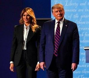 President Donald Trump stands on stage with first lady Melania Trump after the first presidential debate. President Trump and first lady Melania Trump have tested positive for the coronavirus. (AP Photo/Julio Cortez)