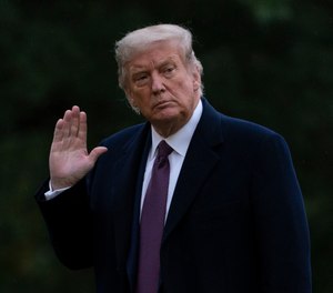 President Donald Trump waves as he walks from Marine One to the White House in Washington, Oct. 1, 2020.