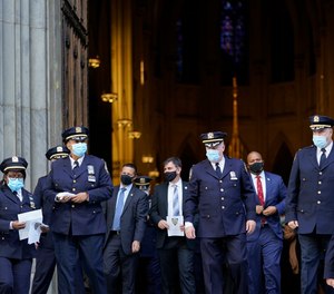 Members of the New York Police Department leave a service honoring the 46 members of the NYPD who have died due to COVID-19 related illness, Monday, Oct. 5, 2020, at St. Patrick's Cathedral in New York.