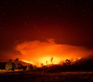 In this Sept. 16, 2020 photo, the August Complex Fire burns near Lake Pillsbury in the Mendocino National Forest, Calif. The August Complex, California's largest-ever wildfire, surpassed 1 million acres on Monday. (AP Photo/Noah Berger, File)
