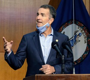 Virginia Gov. Ralph Northam answers a reporter's question during a news briefing in Richmond, Va.