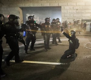 In this July 29, 2020, file photo, a demonstrator is pepper sprayed during a Black Lives Matter protest at the Mark O. Hatfield United States Courthouse in Portland, Ore.