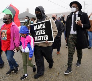 People march during a protest rally for Marcellis Stinnette who was killed by Waukegan Police last Tuesday in Waukegan, Ill., Thursday, Oct. 22, 2020.