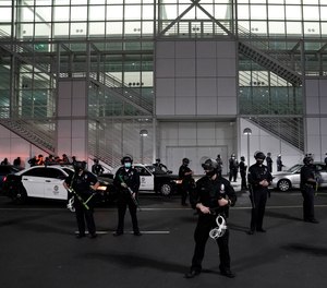 Police stand guard during a protest on Election Day, Tuesday, Nov. 3, 2020, in Los Angeles.