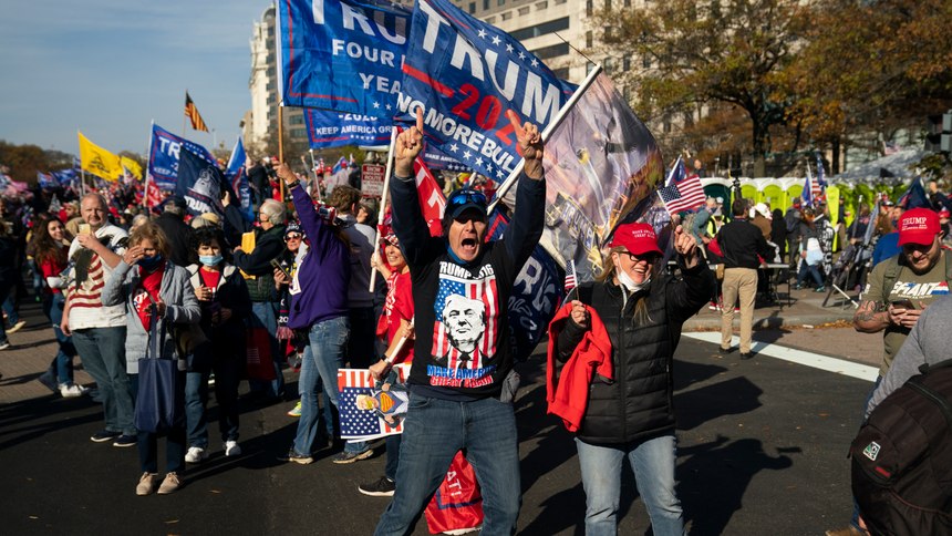 Supporters of President Donald Trump cheer as his motorcade drives past a rally of supporters near the White House, Saturday, Nov. 14, 2020, in Washington.