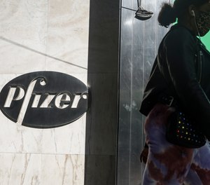 In this Nov. 9, 2020, file photo, pedestrians walk past Pfizer world headquarters in New York. Pfizer said Friday, Nov. 20, 2020, it is asking U.S. regulators to allow emergency use of its COVID-19 vaccine, starting the clock on a process that could bring limited first shots as early as next month.