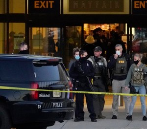 FBI officials and police stand outside the Mayfair Mall after a shooting, Friday, Nov. 20, 2020, in Wauwatosa, Wis.