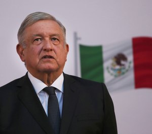 Mexican President Andrés Manuel López Obrador stands during the commemoration of his second anniversary in office, at the National Palace in Mexico City, on Tuesday, December 1, 2020.