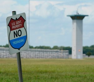 A no trespassing sign is displayed outside the federal prison complex in Terre Haute, Ind.