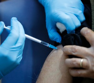 A nurse administers the Pfizer-BioNTech COVID-19 vaccine at Guy's Hospital in London, Tuesday, Dec. 8, 2020. The FDA has approved emergency use of the Pfizer vaccine in the United States, setting off what will be the largest vaccination campaign in U.S. history.