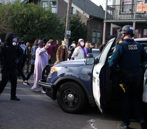 Protesters who have camped for months to prevent a Black and Indigenous family from being forced to leave a home took the property back Tuesday, Dec. 8, 2020, after morning clashes with police, who said they were working to
