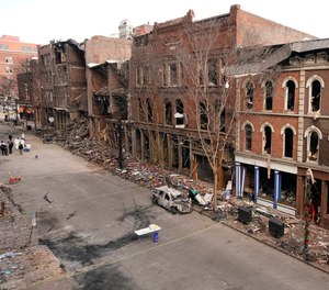 Debris remains on the sidewalks in front of buildings damaged in a Christmas Day explosion Tuesday, Dec. 29, 2020, in Nashville, Tenn.