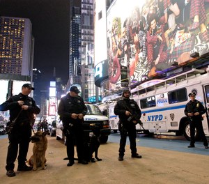 In this Dec. 31, 2011, file photo, police officers stand guard during the New Year's Eve celebration in New York's Times Square.