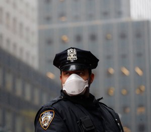 In this, May 1, 2020, file photo, a New York Police officer wears a mask to protect against coronavirus.