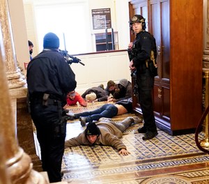 U.S. Capitol Police hold protesters at gun-point near the House Chamber inside the U.S. Capitol on Wednesday, Jan. 6, 2021, in Washington.