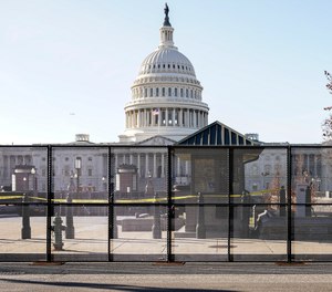 Capitol police officers stand outside of fencing that was installed around the exterior of the Capitol grounds, Thursday, Jan. 7, 2021 in Washington.