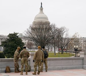 With the U.S. Capitol Building in view, members of the military stand in Washington, Friday, Jan. 8, 2021, in response to supporters of President Trump who stormed the Capitol.