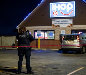 Chicago and Evanston police investigate the scene of a shooting outside an IHOP restaurant in Evanston, Ill., Saturday night, Jan. 9, 2021.