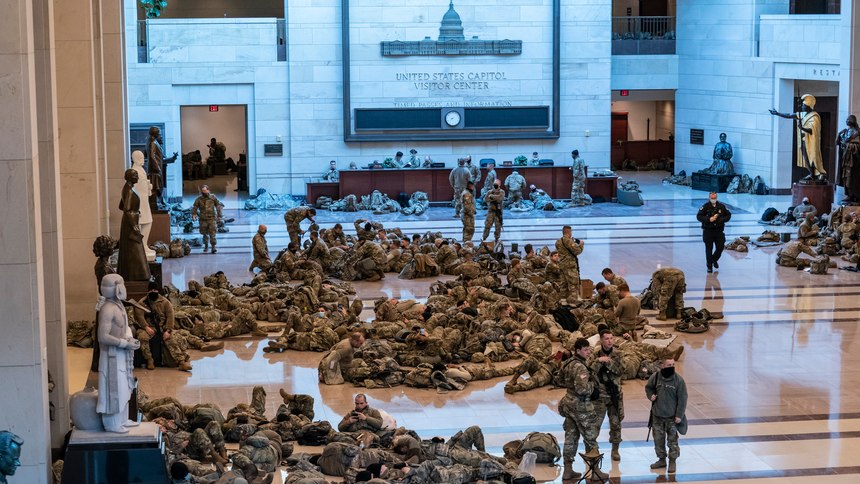 Hundreds of National Guard troops hold inside the Capitol Visitor's Center to reinforce security at the Capitol in Washington, Wednesday, Jan. 13, 2021.