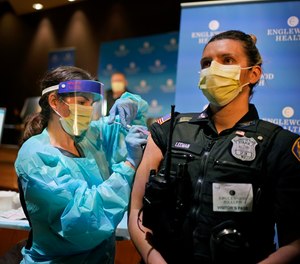 Police officer Jennifer Leeman is receives a COVID-19 vaccine at Englewood Health in Englewood, N.J., Thursday, Jan. 14, 2021.