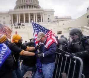 In this Jan. 6, 2021, file photo rioters try to break through a police barrier at the Capitol in Washington.