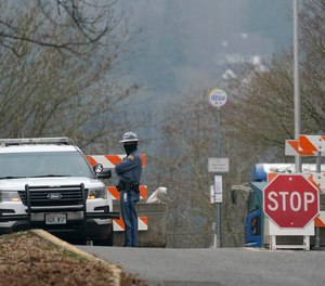 A Washington State Patrol trooper staffs a vehicle checkpoint Wednesday, Jan. 20, 2021, at the Capitol in Olympia, Wash.