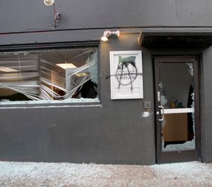 A crowd carrying anti-President Joe Biden and anti-police signs marched in the streets and damaged the headquarters of the Democratic Party of Oregon, Wednesday, Jan. 20, 2021.