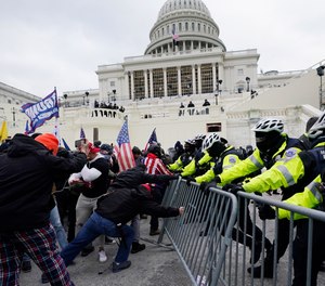 Trump supporters try to break through a police barrier, Wednesday, Jan. 6, 2021, at the Capitol in Washington.