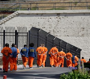 General population inmates walk in a line at San Quentin State Prison in San Quentin, Calif.