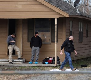 Investigators work at the scene of a shooting on Tuesday, Feb. 2, 2021 in Muskogee, Okla.